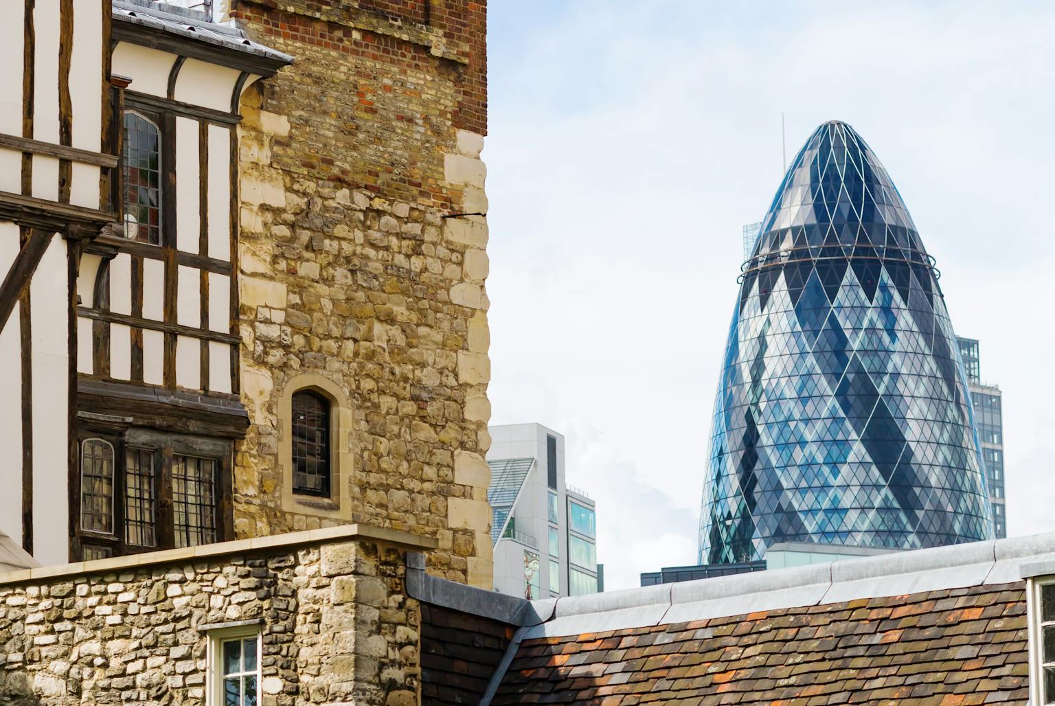 Historic brick building contrasted with modern glass skyscraper