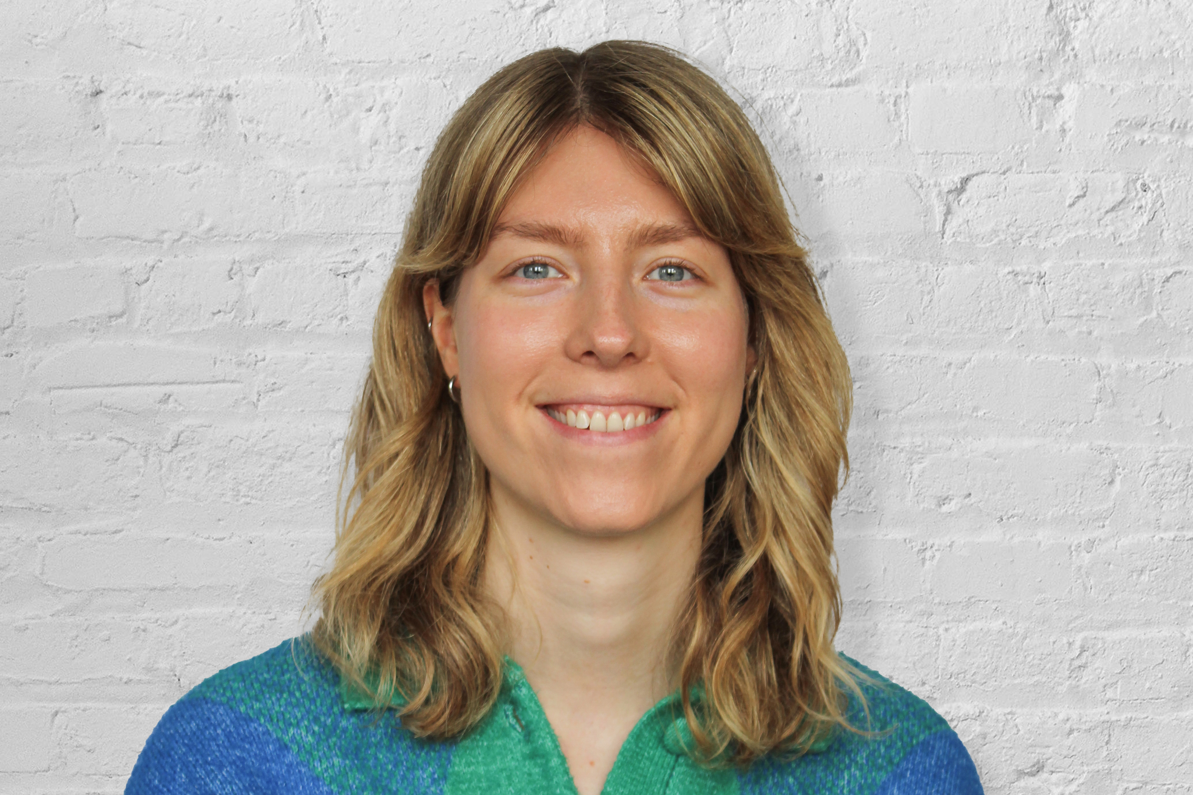 person in front of brick wall