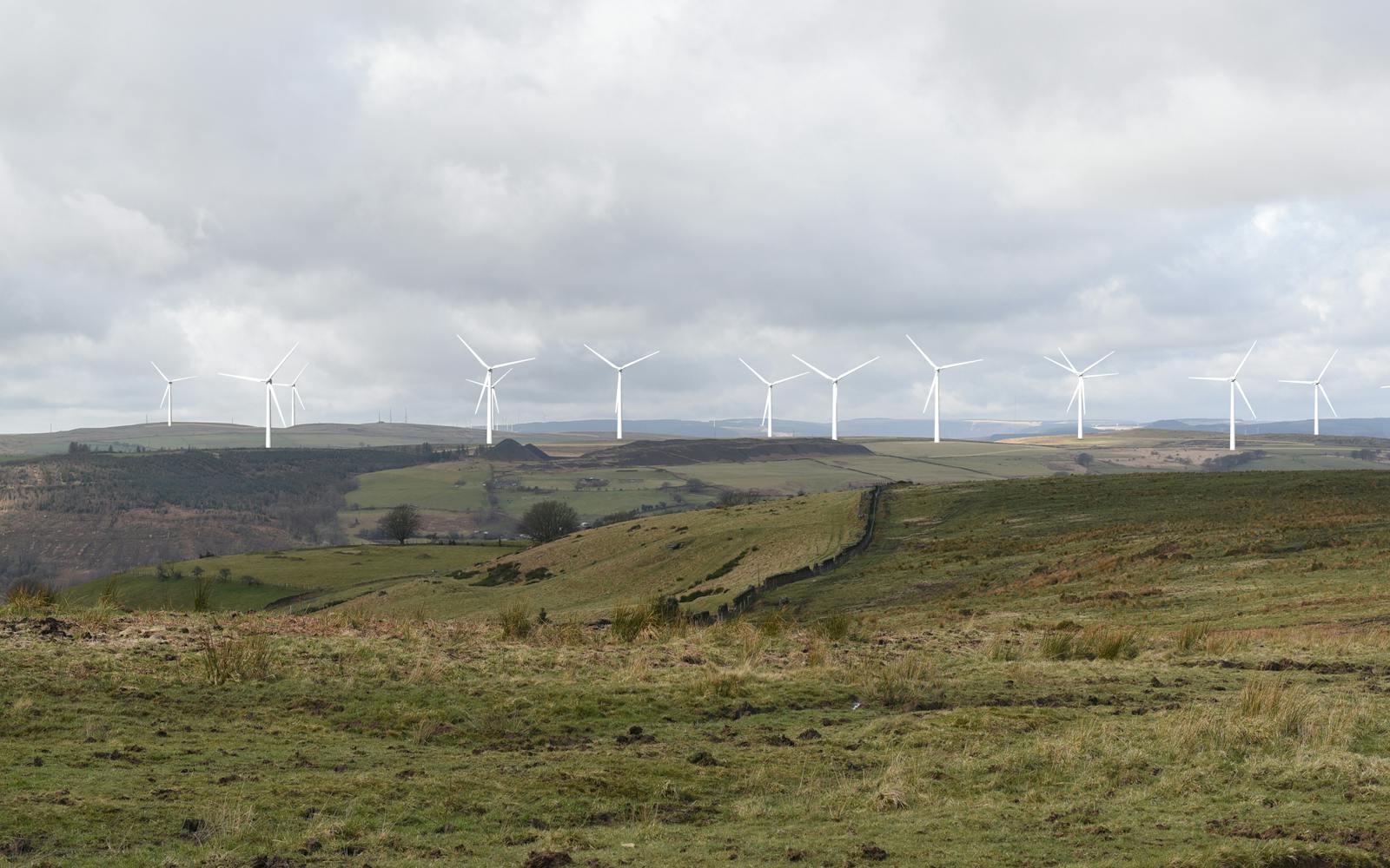Wind turbines on a hill generating clean, renewable energy