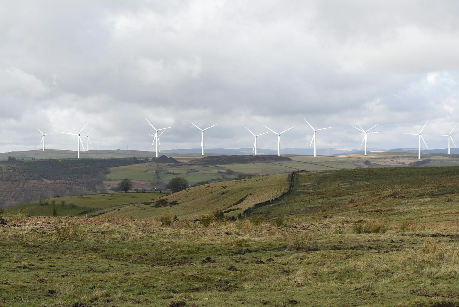 Wind turbines on a hill generating clean, renewable energy