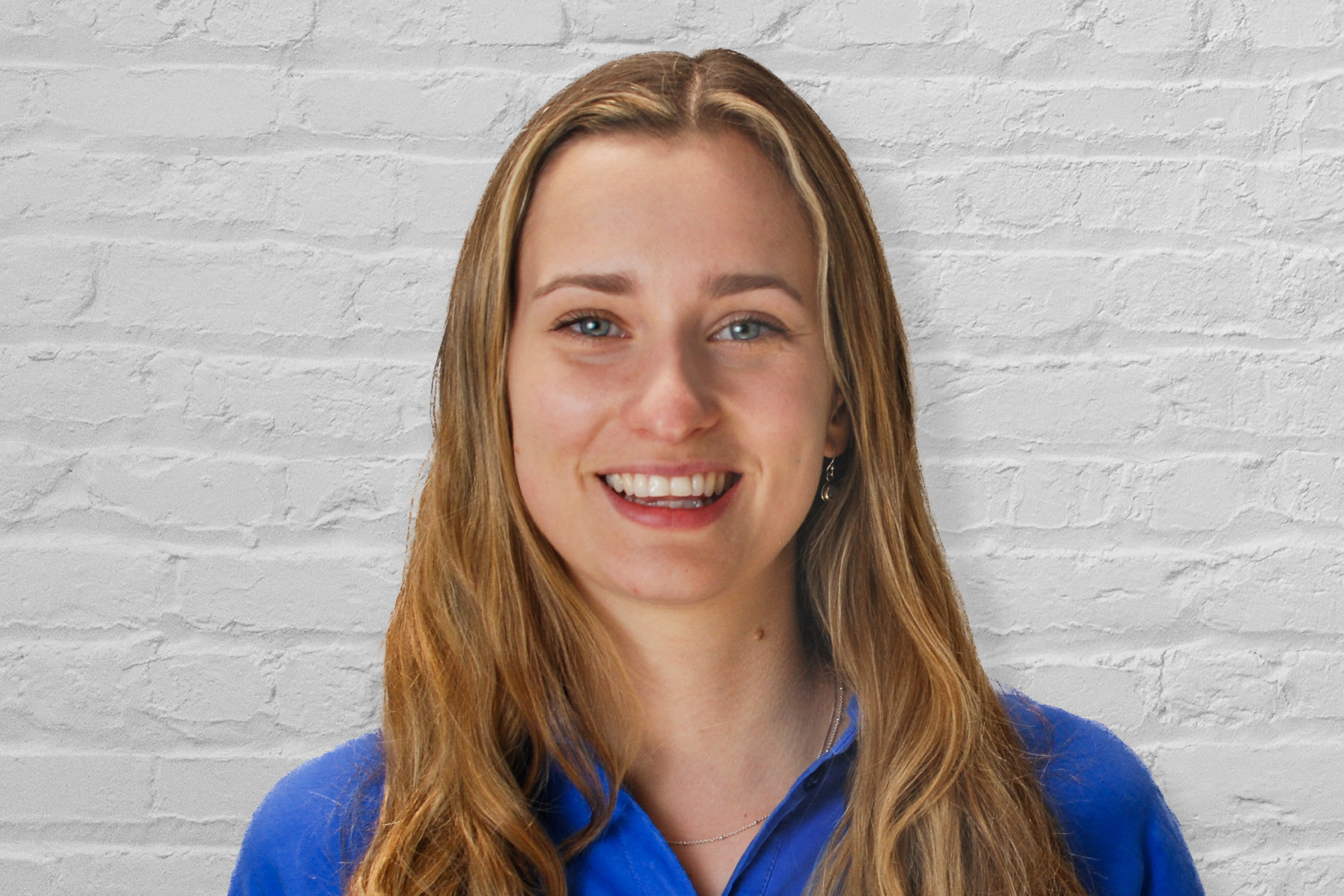 Person in front of brick wall