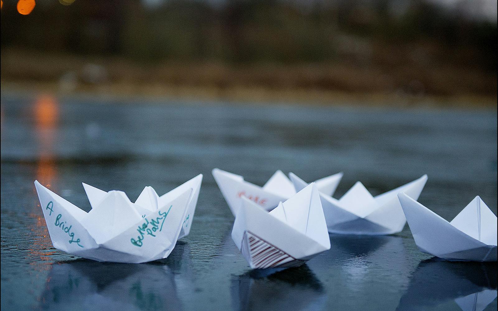 Folded pieces of paper with writing on