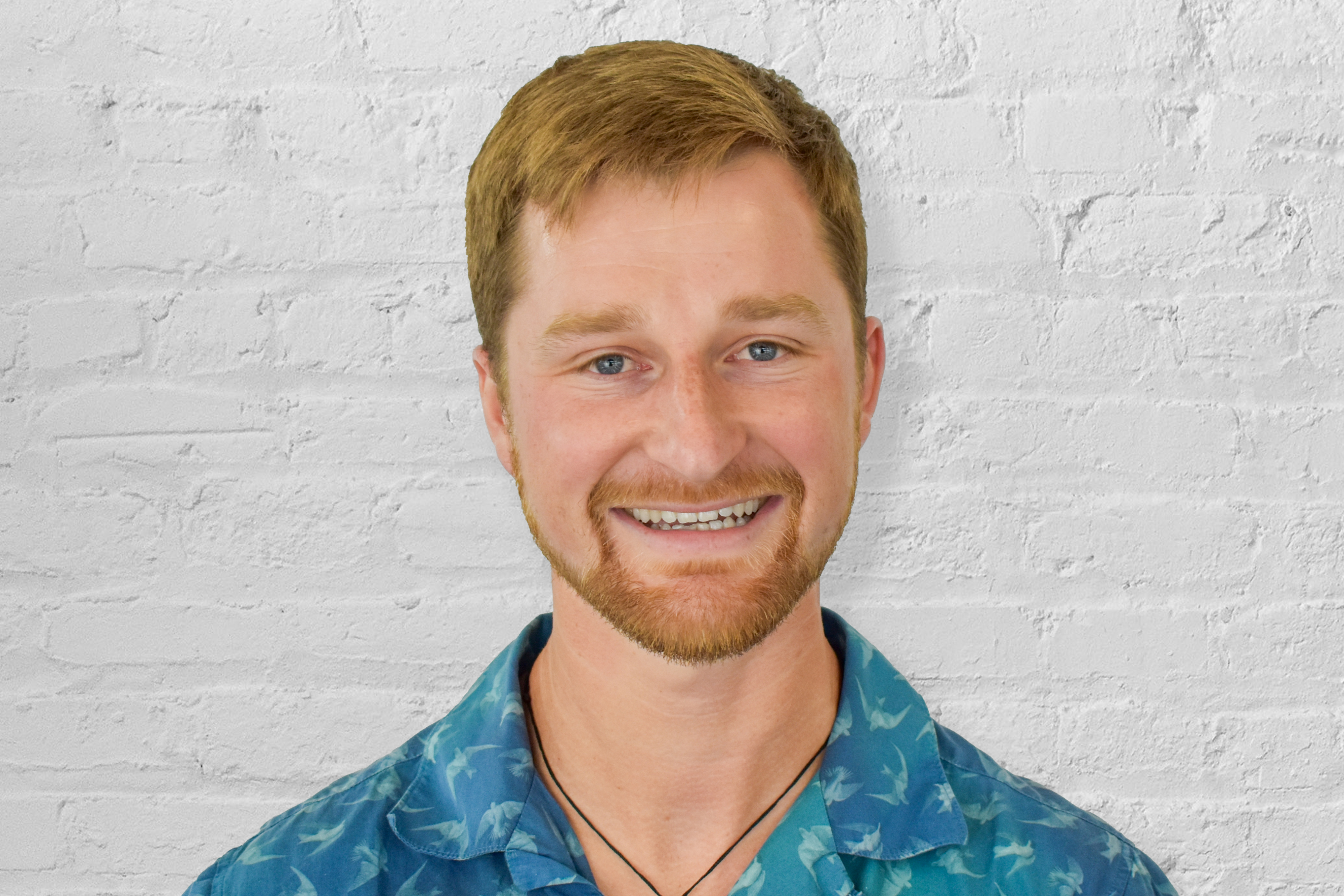 Person in front of brick wall