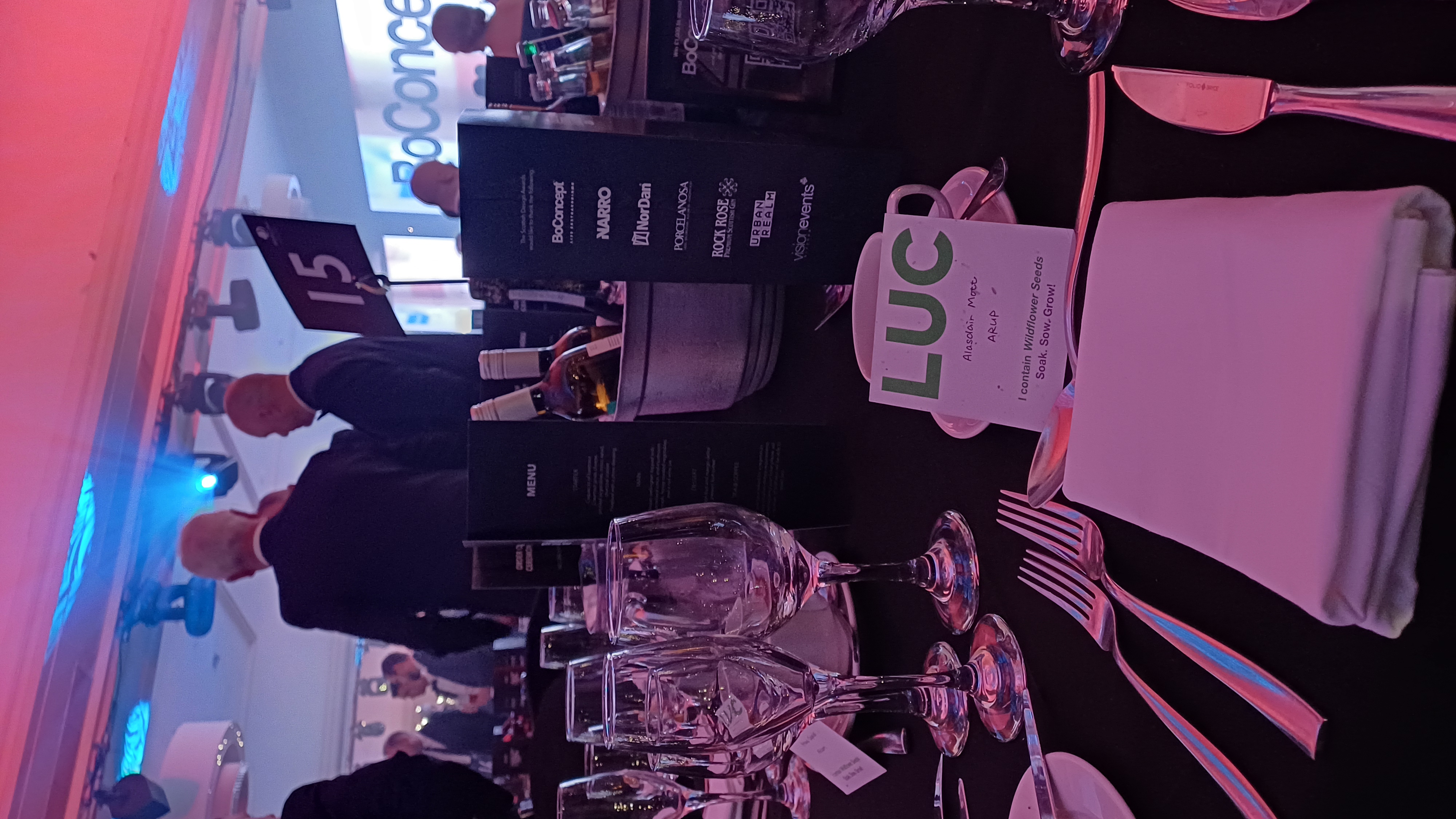 Image of table setting at awards with LUC seed coasted used as name card