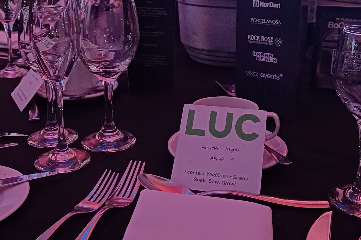 Image of table setting at awards with LUC seed coasted used as name card