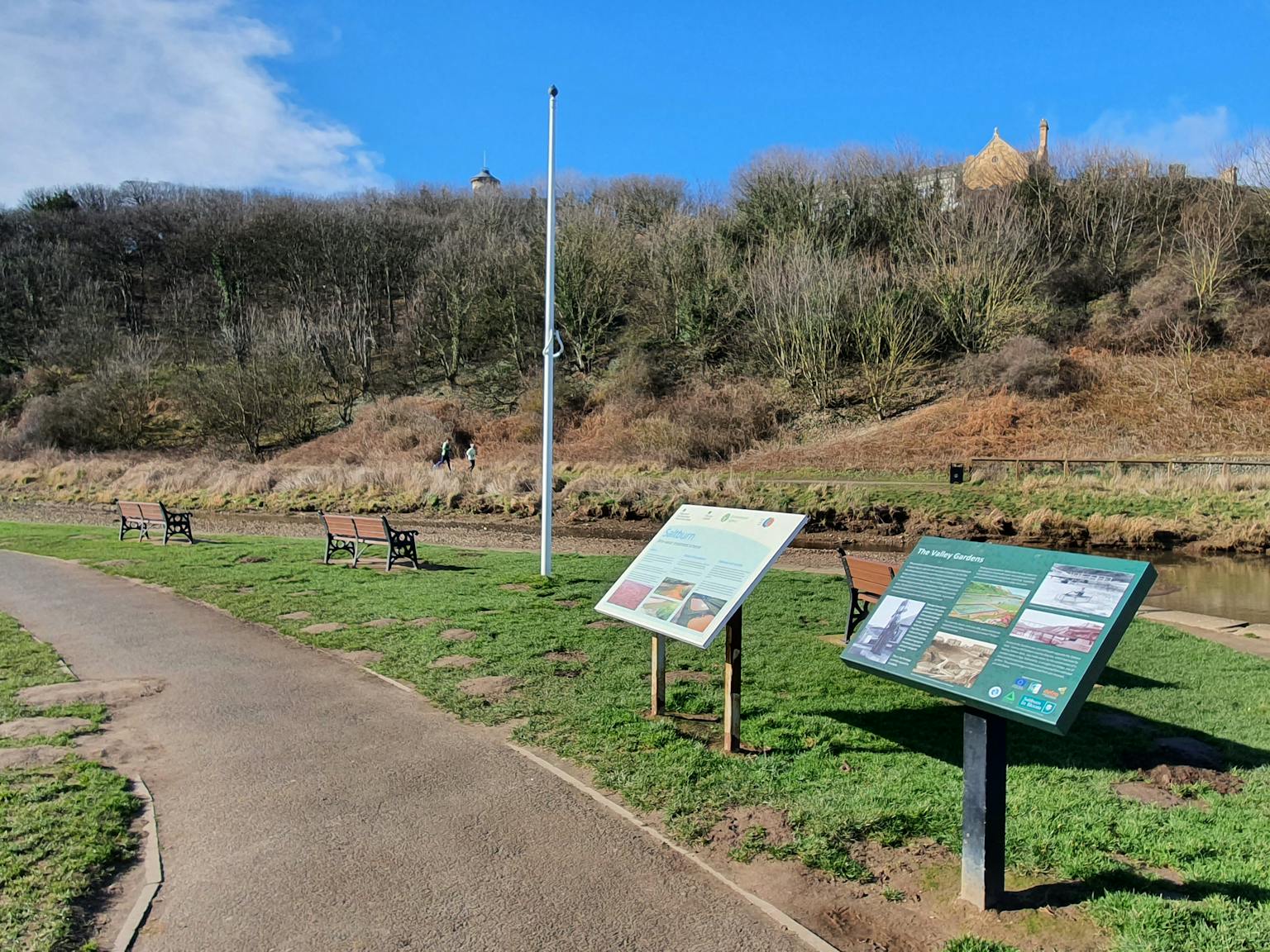 Path through grass area with to information boards