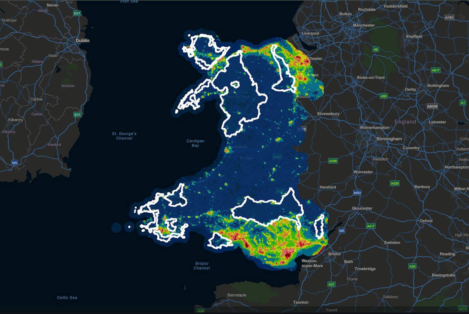 Map of Wales colored by region, showing areas with the darkest skies. The title reads "Wales Dark Skies Map." Text labels identify regions with darkest skies as Anglesey, Gwynedd, and Conwy.