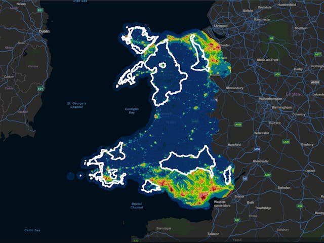 Map of Wales colored by region, showing areas with the darkest skies. The title reads "Wales Dark Skies Map." Text labels identify regions with darkest skies as Anglesey, Gwynedd, and Conwy.