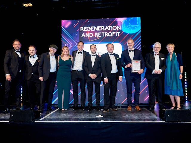 Group of people standing on stage accepting award