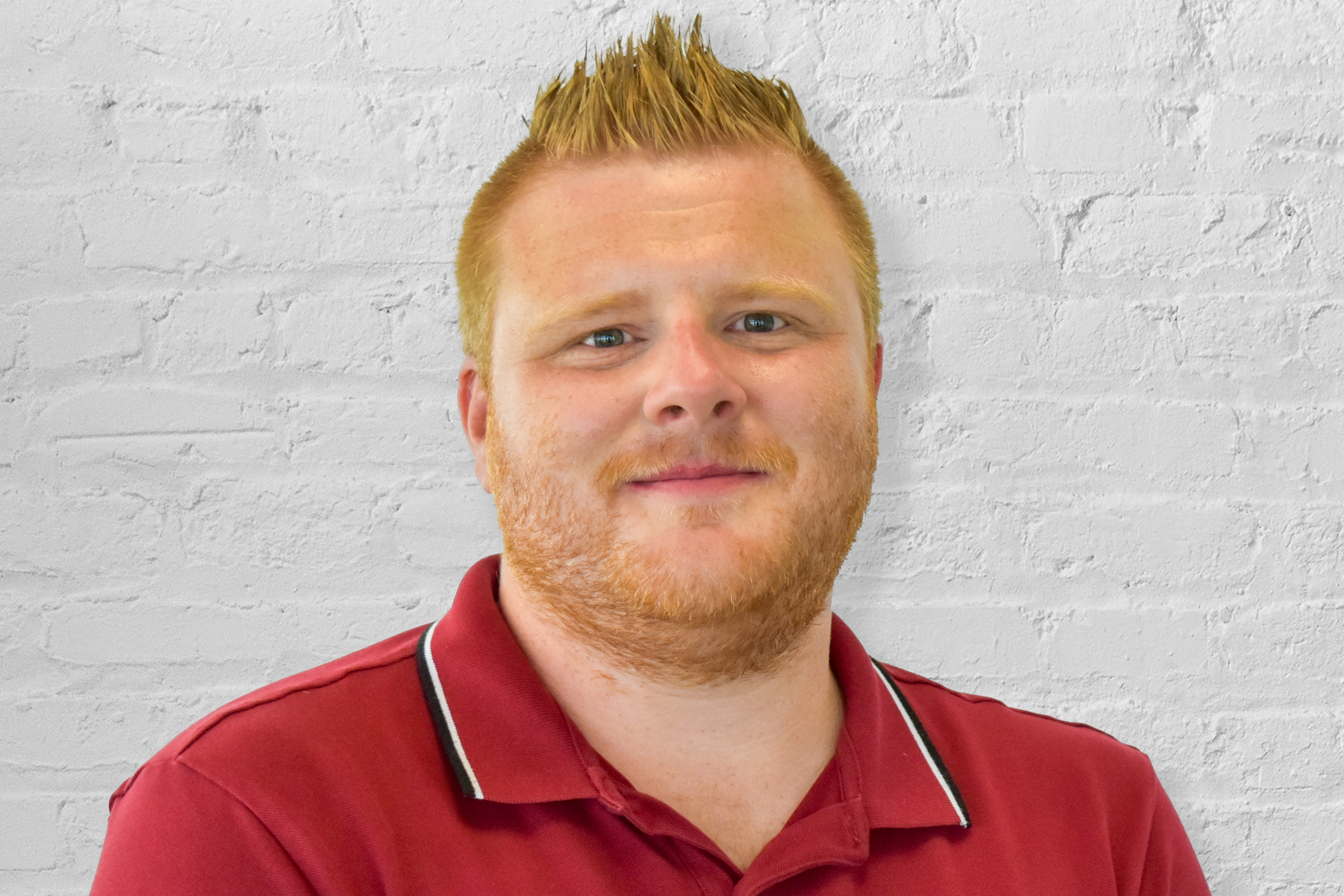 person in front of brick wall