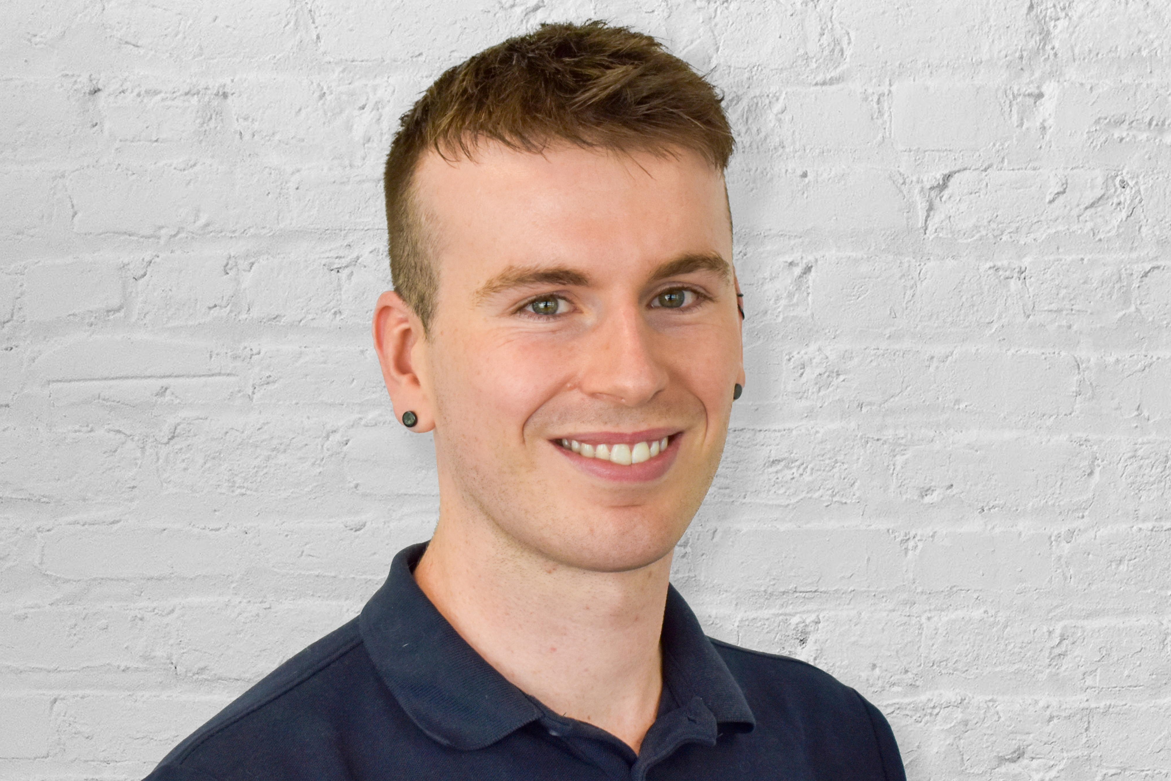 person in front of brick wall