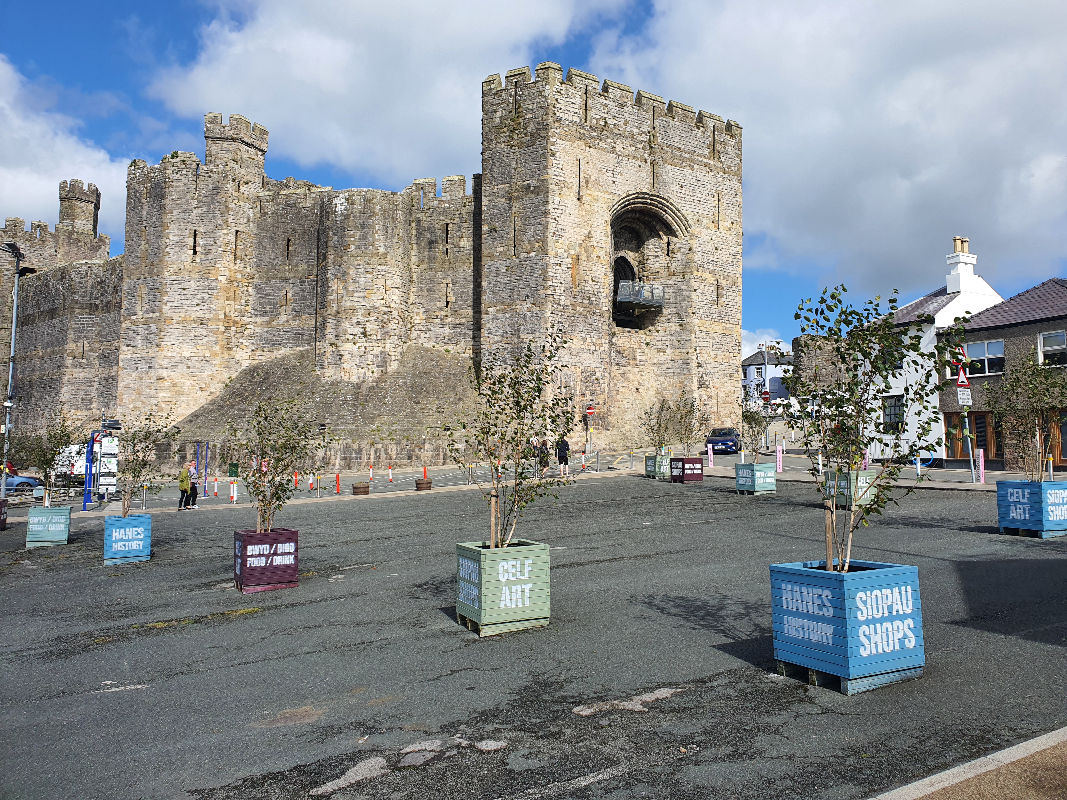 A large castle with a square courtyard filled with planters.