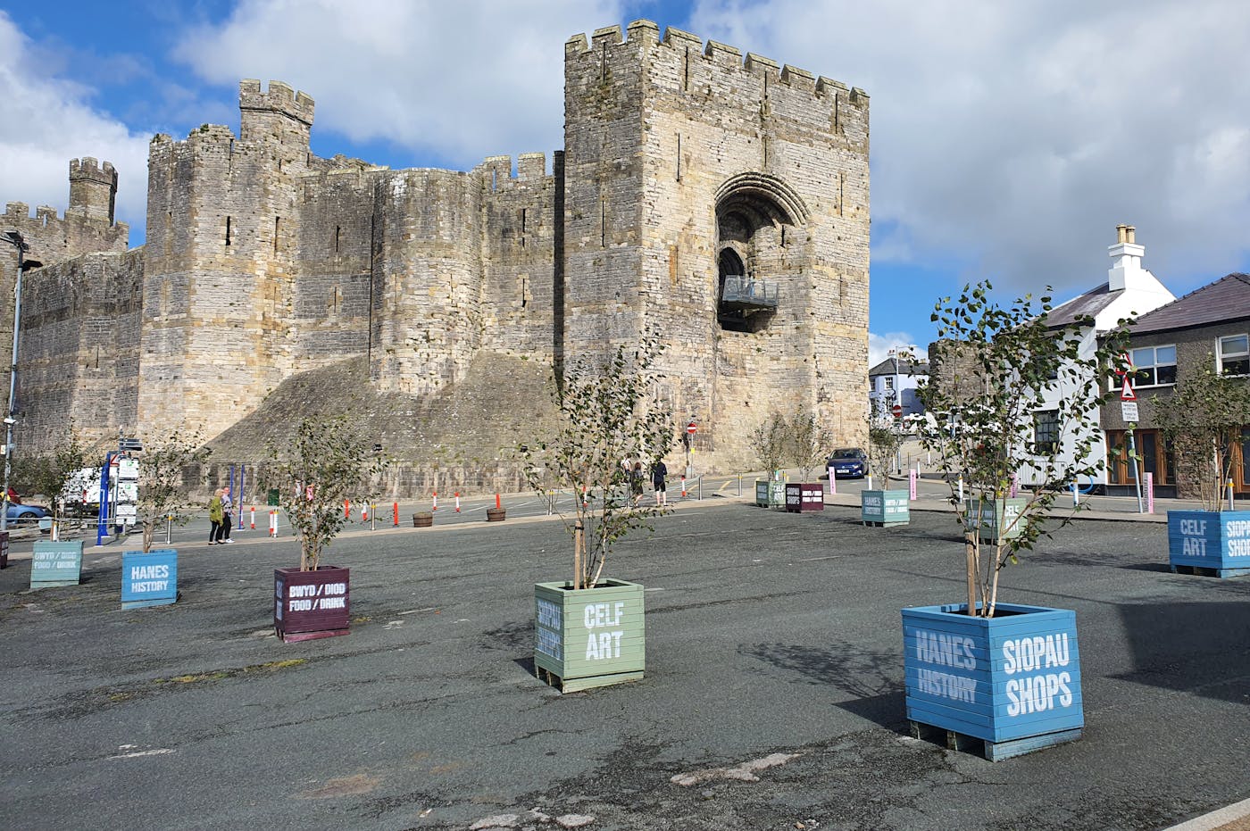 A large castle with a square courtyard filled with planters.