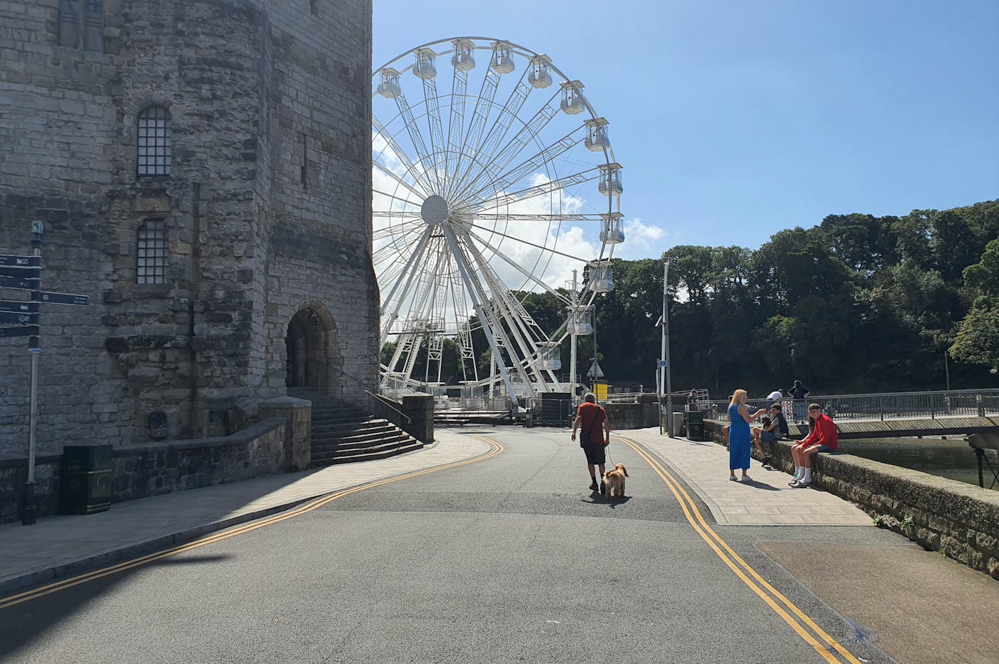A Ferris wheel behind a castle wall