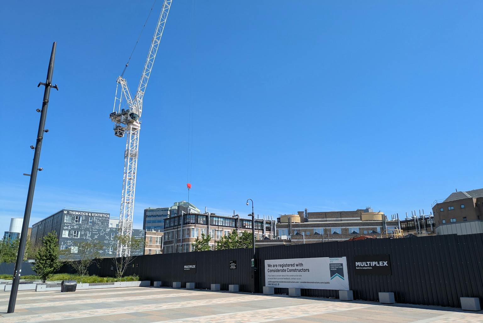 a crane with a clear sunny sky in the background.