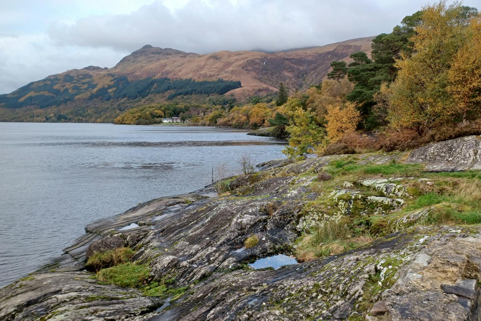 A Scottish landscape with a loch and mountains