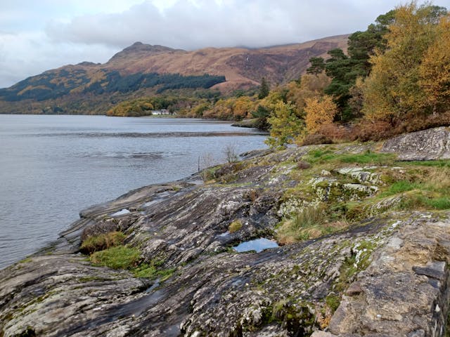 A Scottish landscape with a loch and mountains