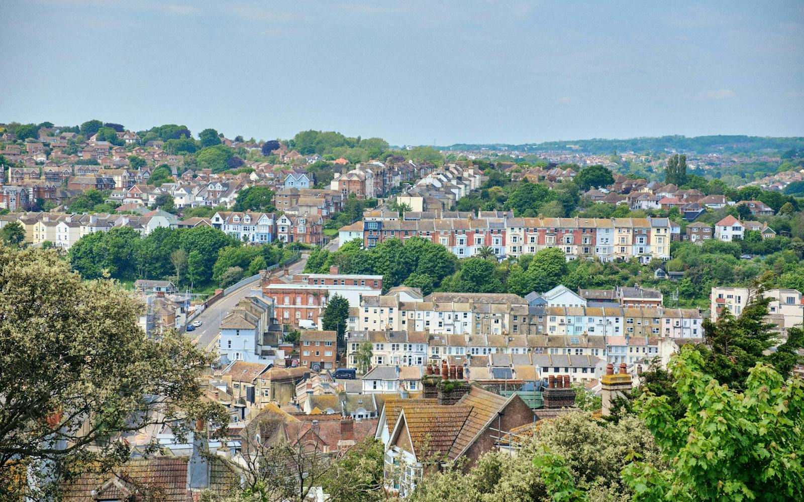 A hillside town with colourful houses and abundant greenery.