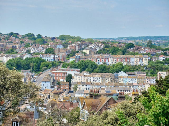 A hillside town with colourful houses and abundant greenery.