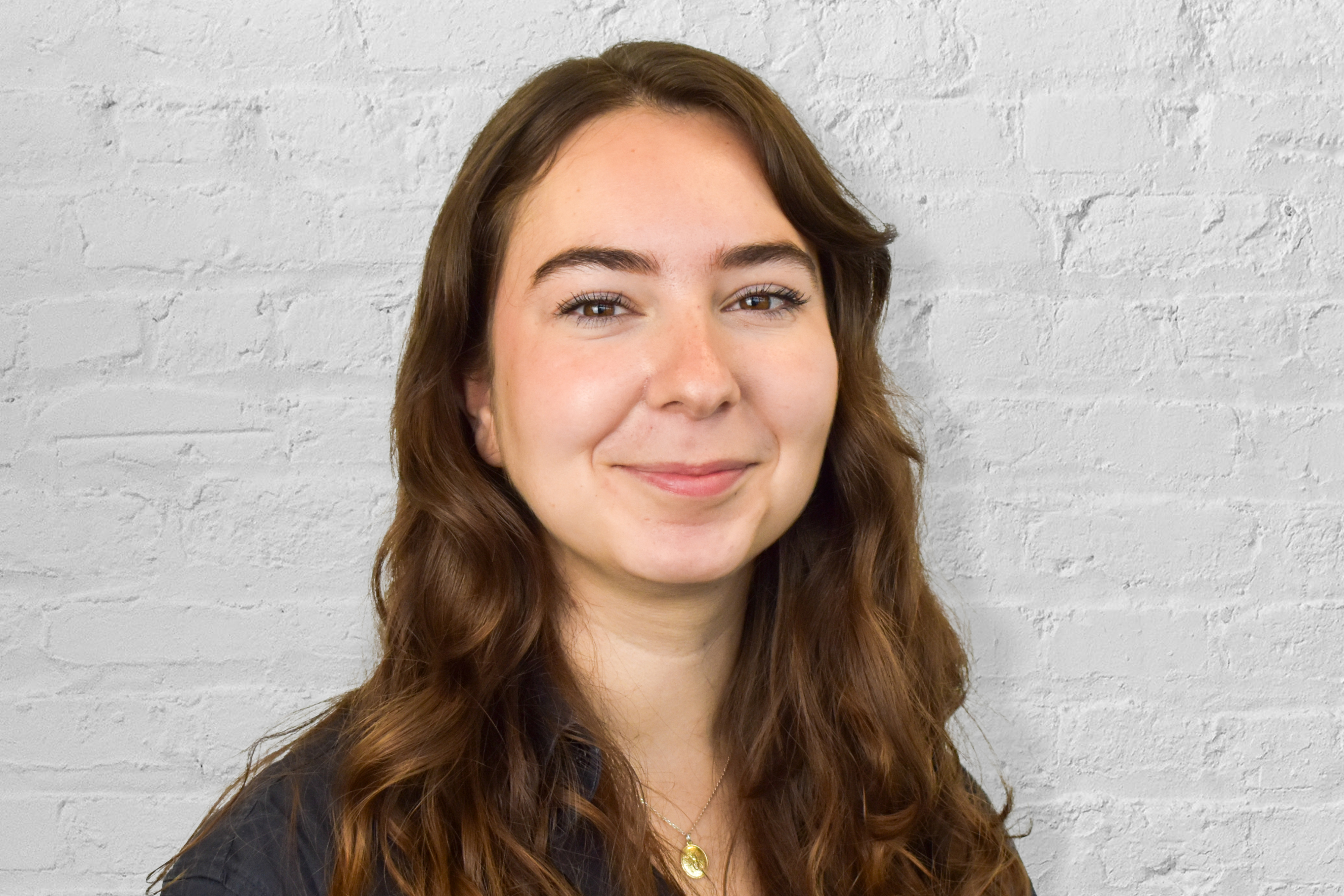 Person in front of brick wall