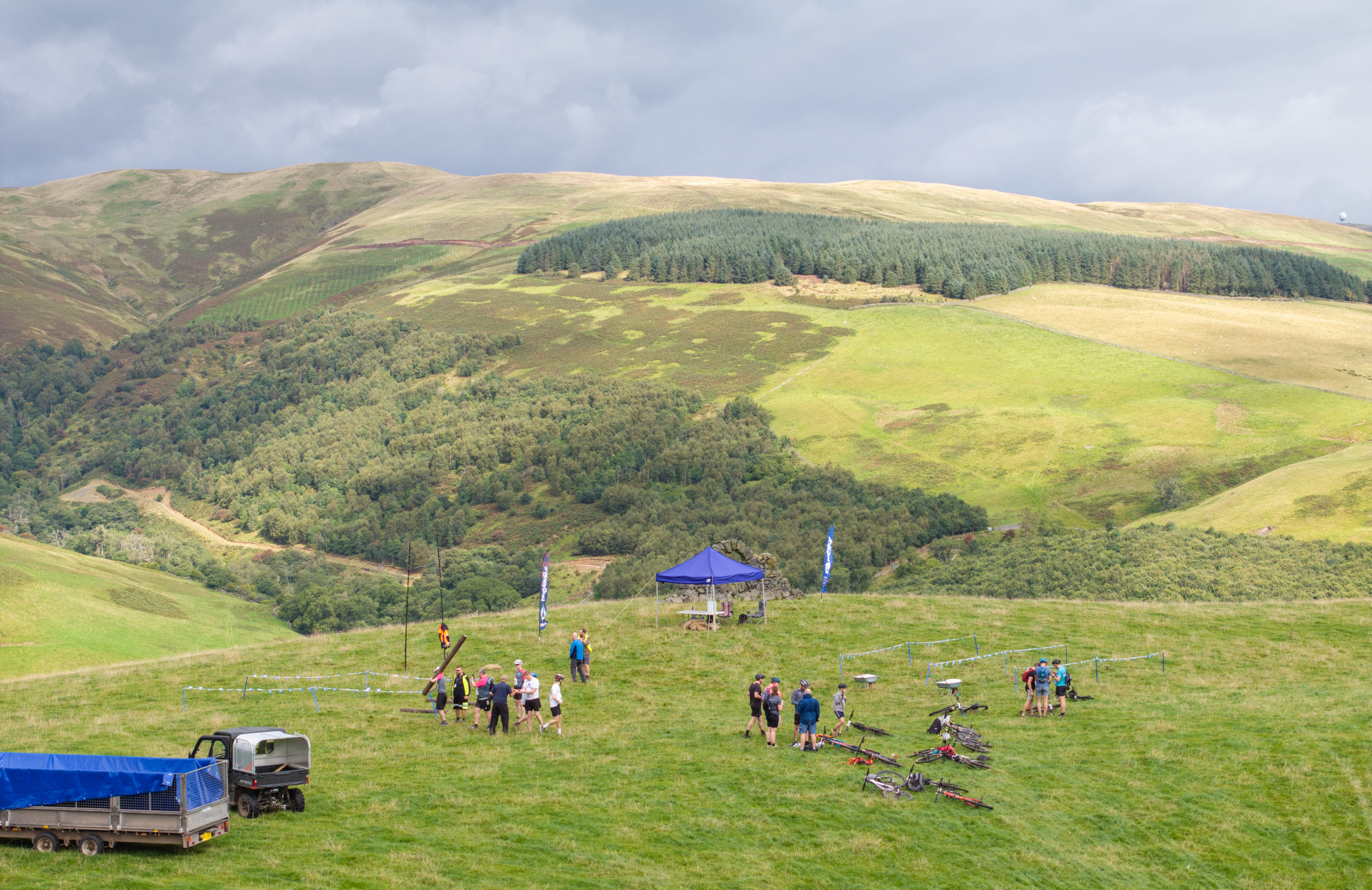 A group of people on a green hill.