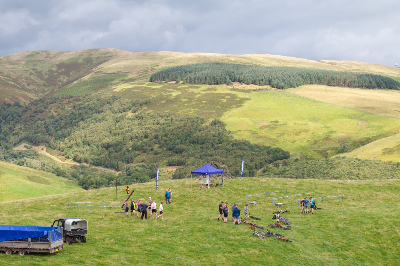 A group of people on a green hill.