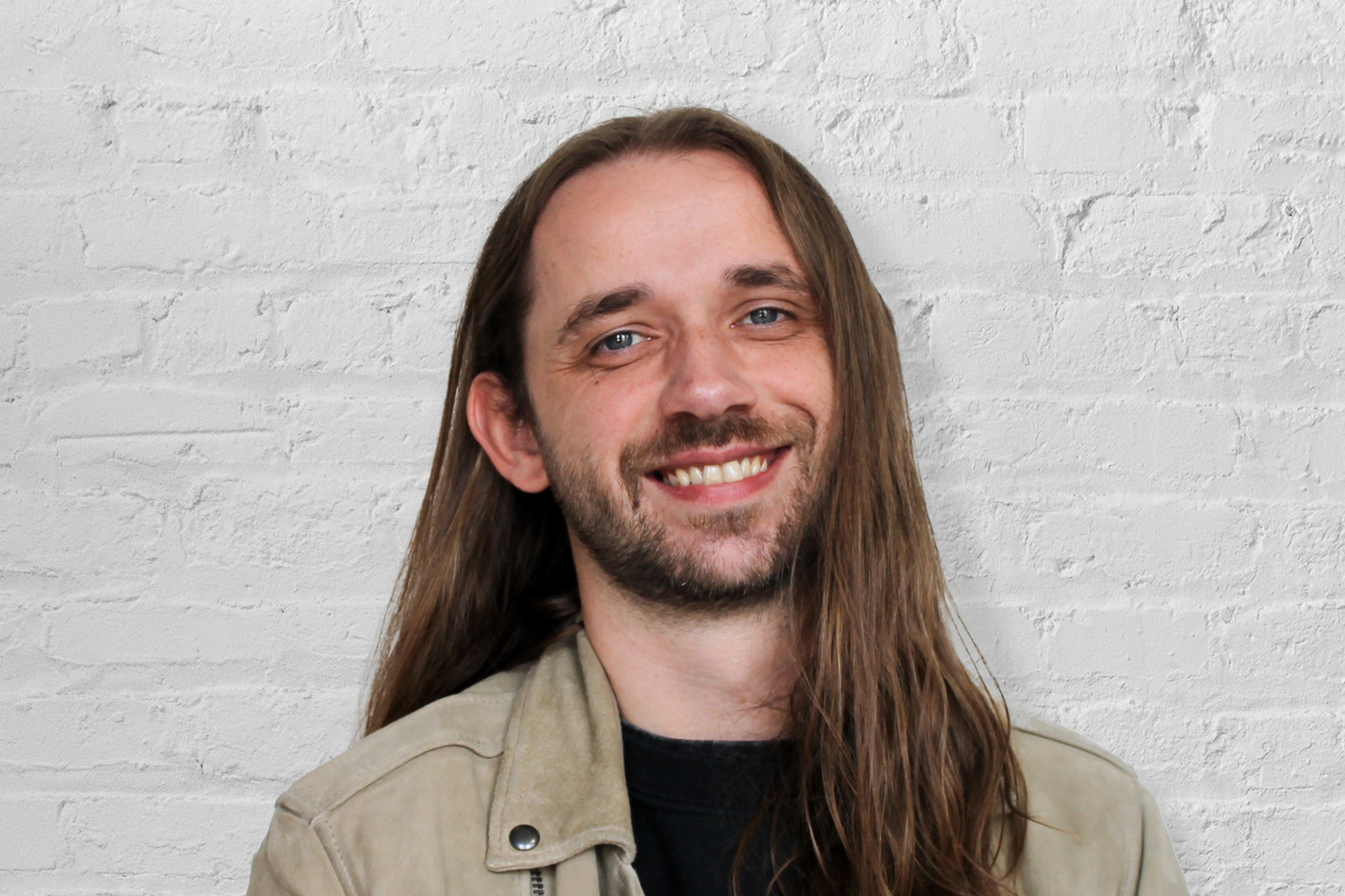 Person in front of a brick wall