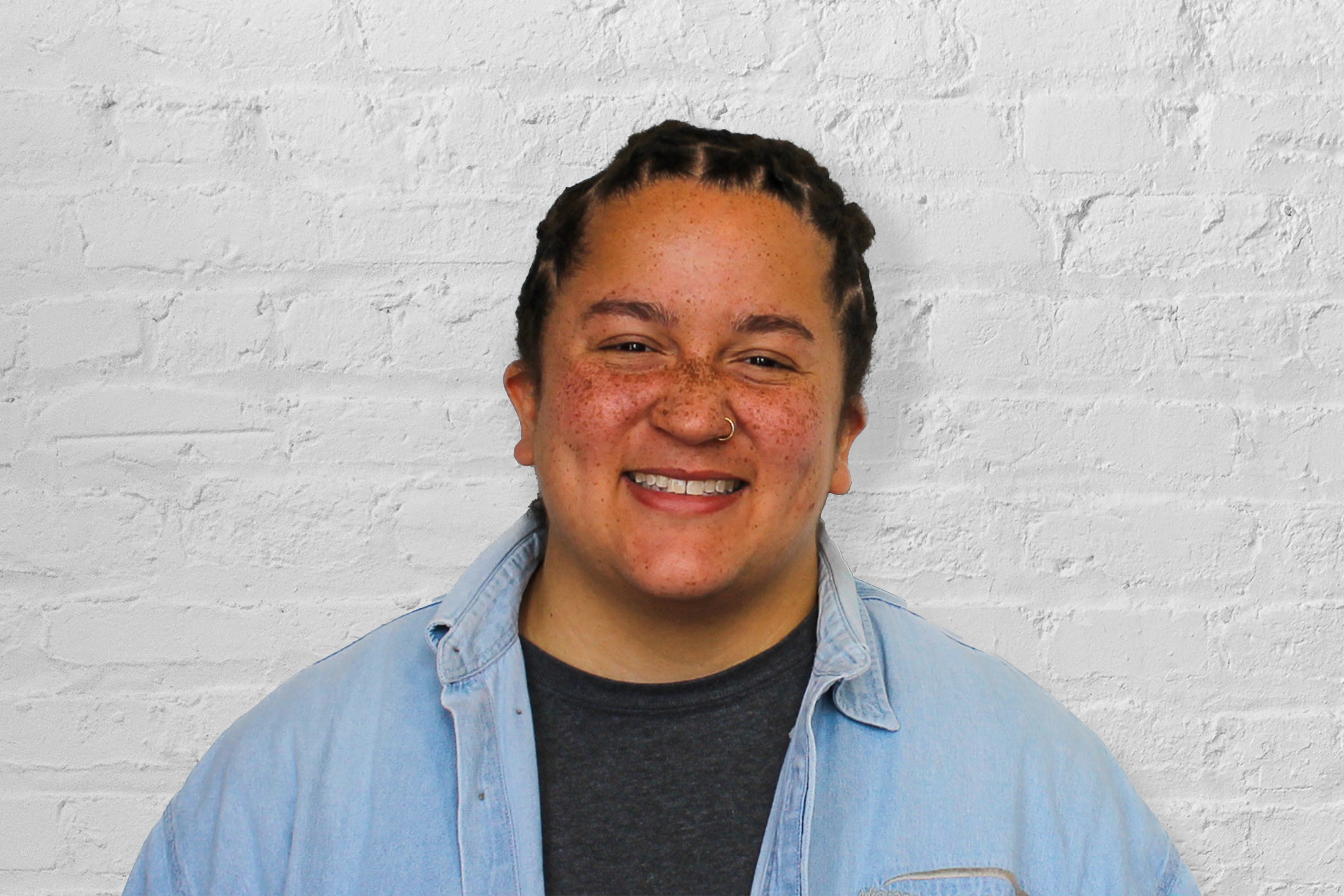 A person in front of a brick wall