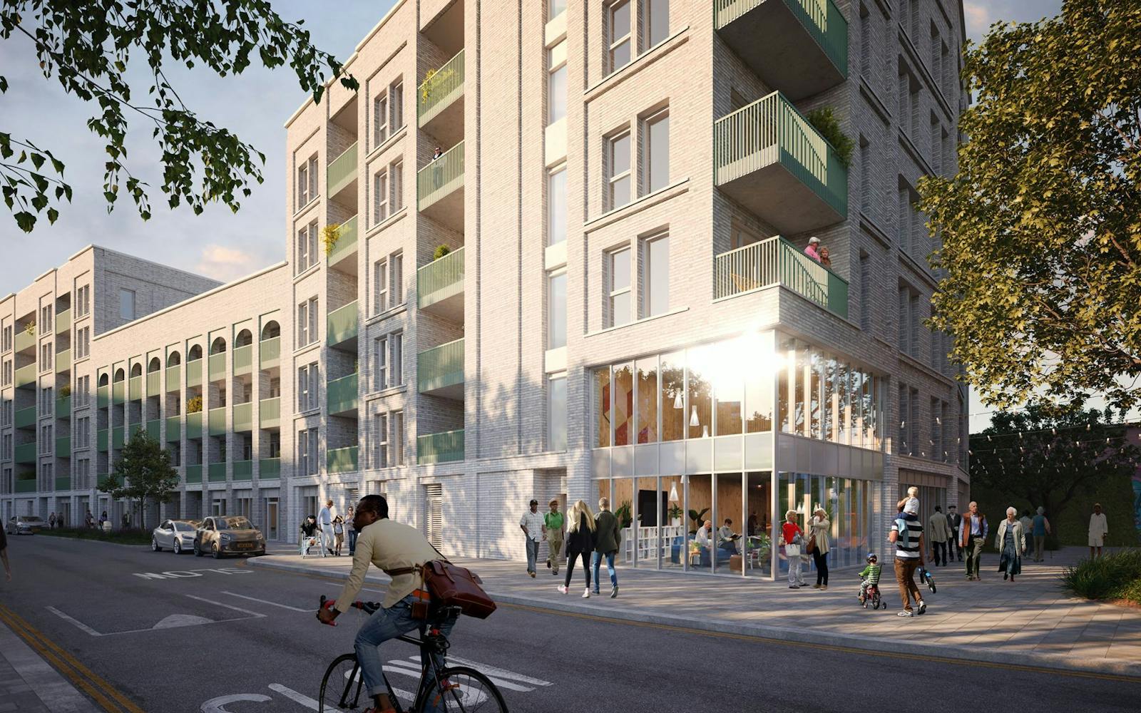 An architectural rendering showing the exterior of a light-colored, multi-story residential building with green balconies and a glass-fronted ground floor, with people walking and a person riding a bicycle on the adjacent street.