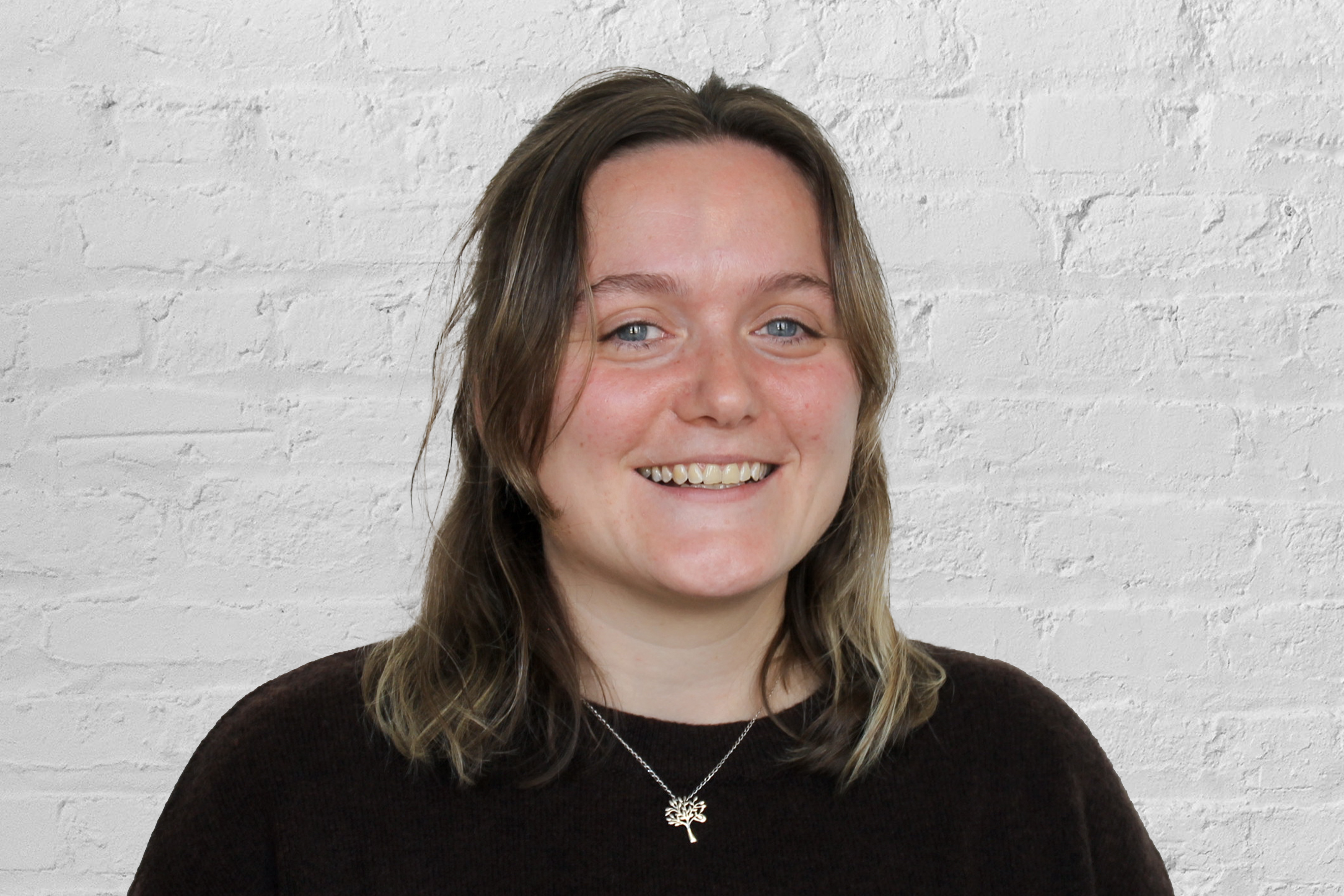 Person in front of a brick wall