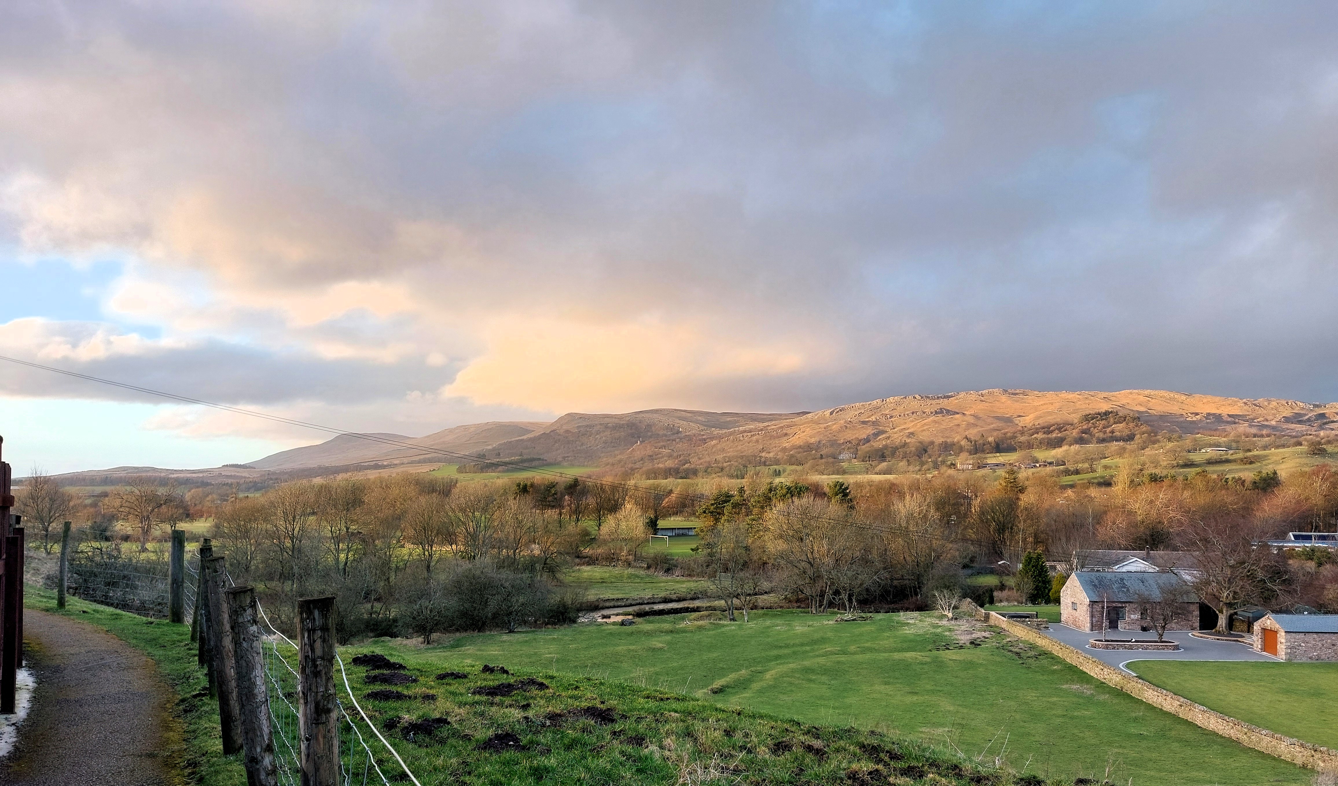 Rolling countryside and hills with a moody, cloudy sky