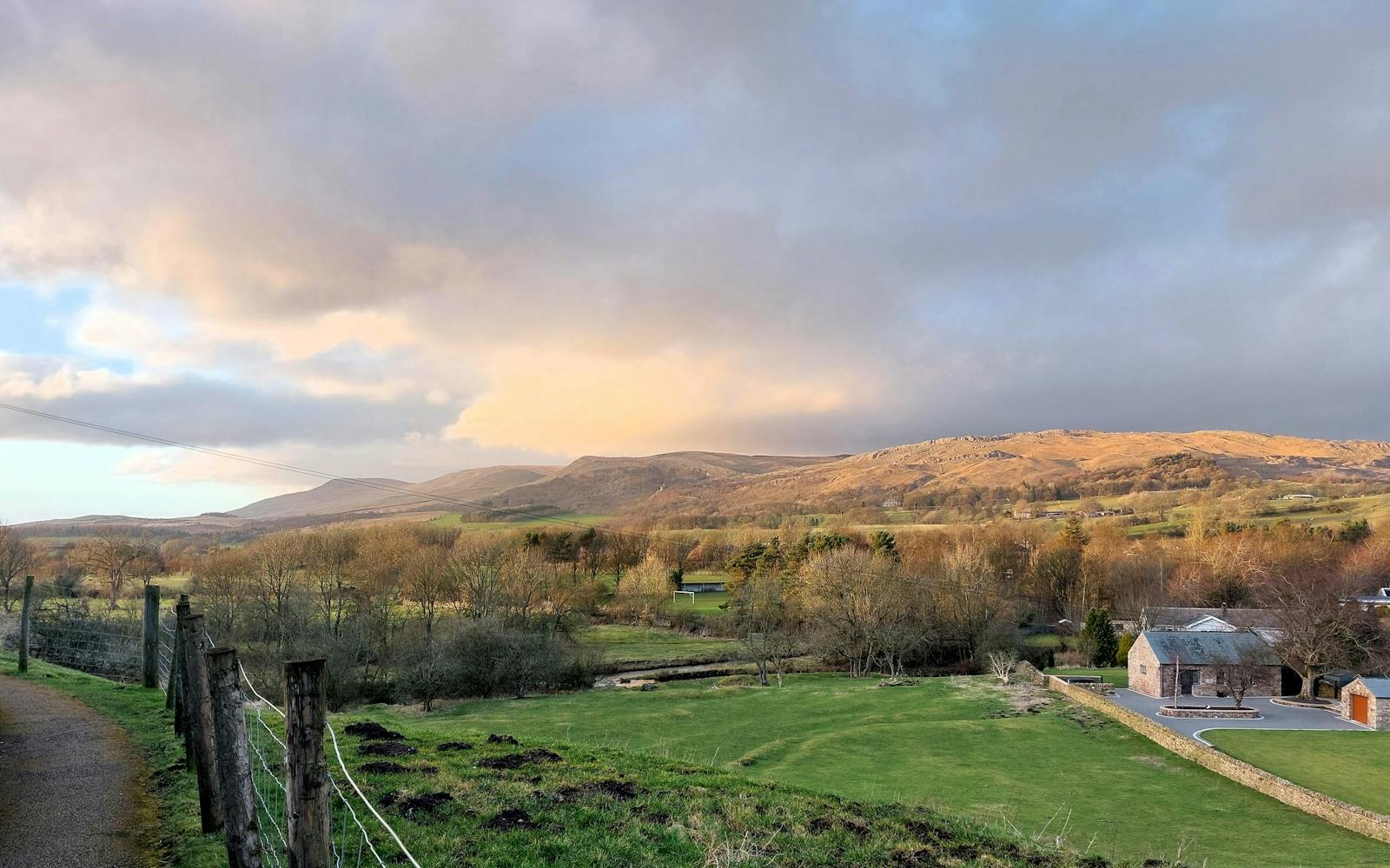 Rolling countryside and hills with a moody, cloudy sky