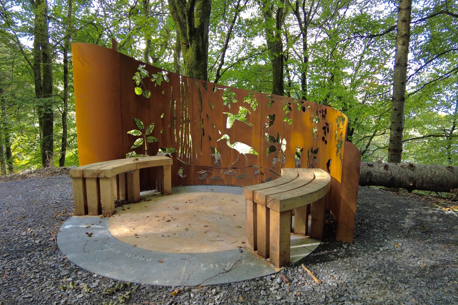 Benches and street furniture surrounded by woodland