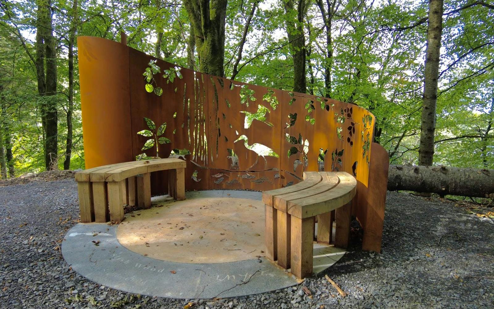 Benches and street furniture surrounded by woodland