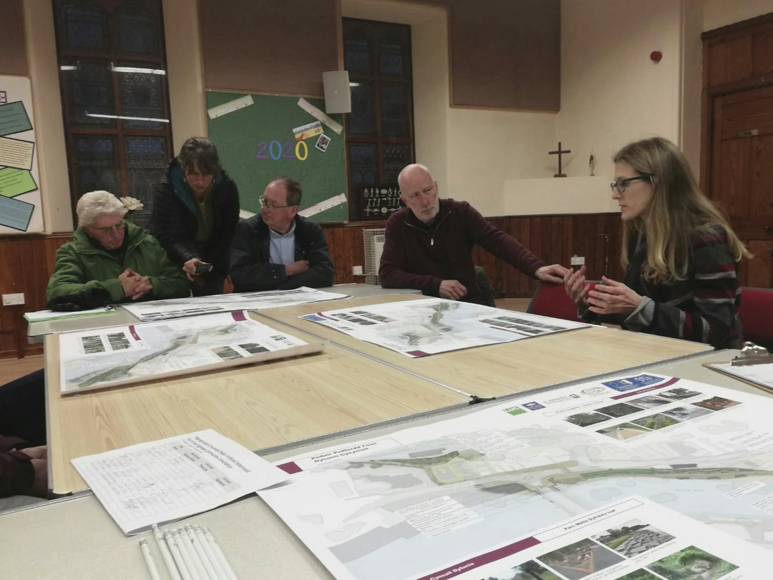 People sat at a table looking at plans