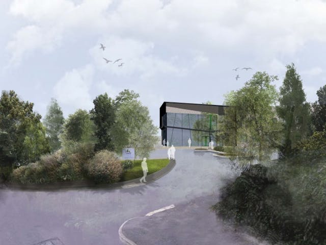 a building with trees and a road