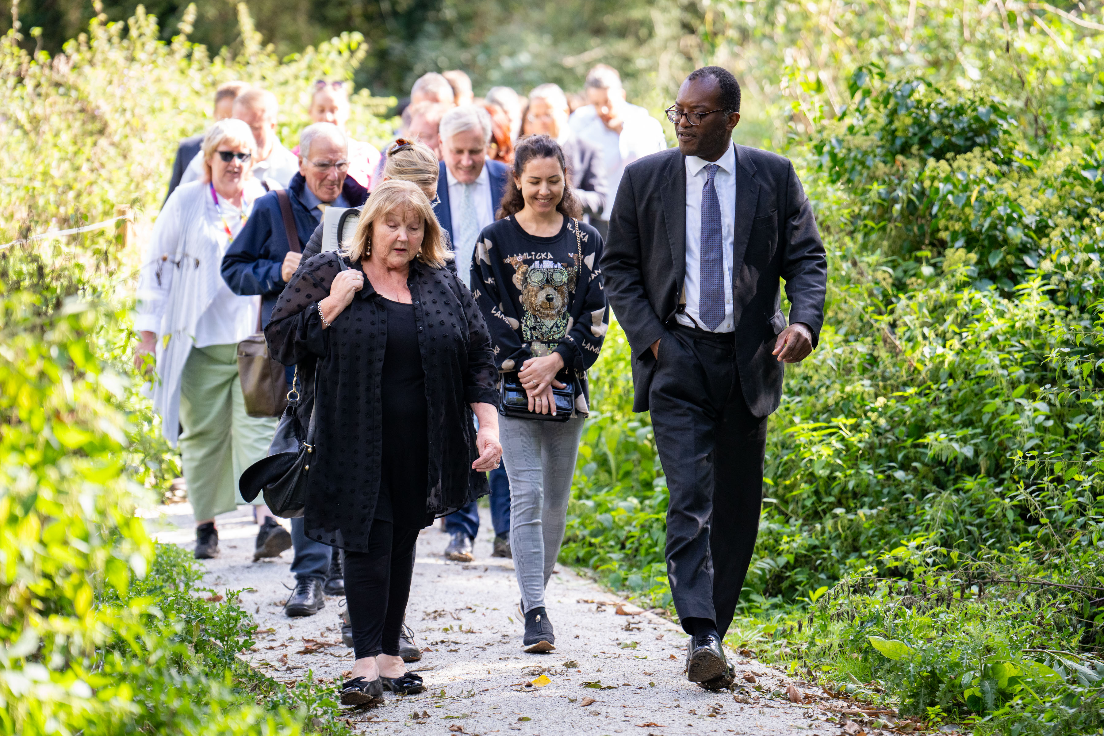 Group of people walking through wild footopath