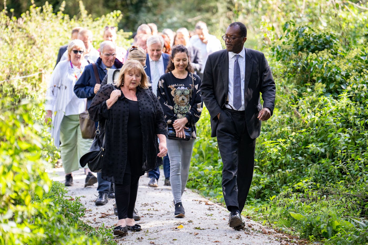 Group of people walking through wild footopath
