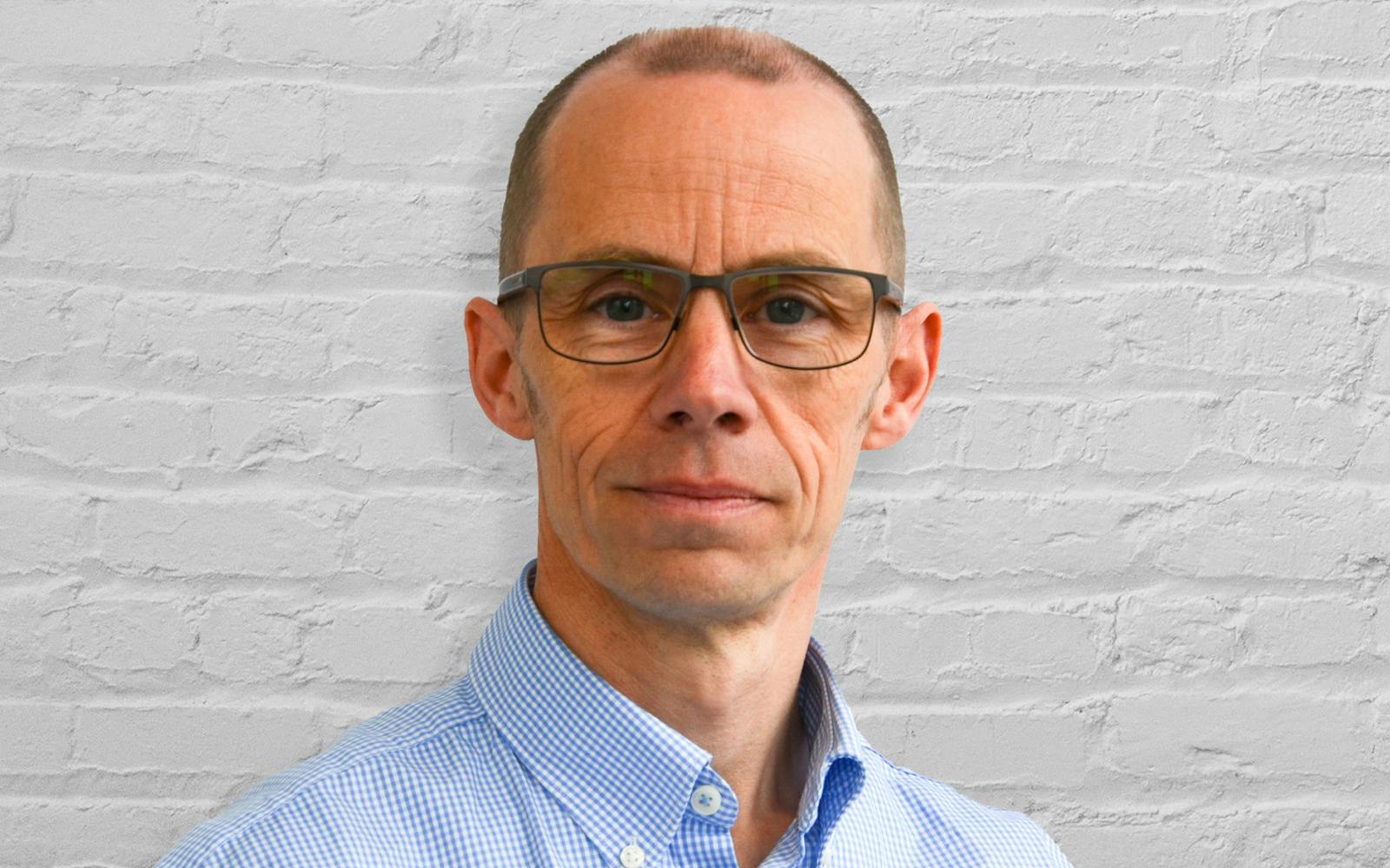 Person in front of white brick wall