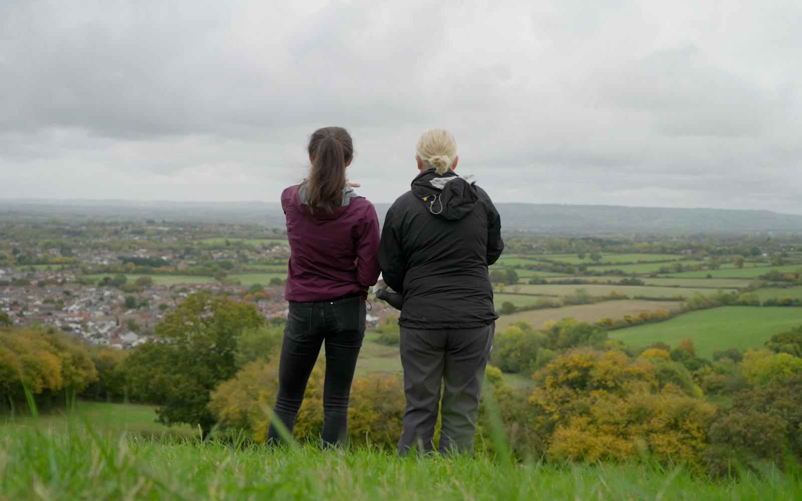 Two people looking over a landscape