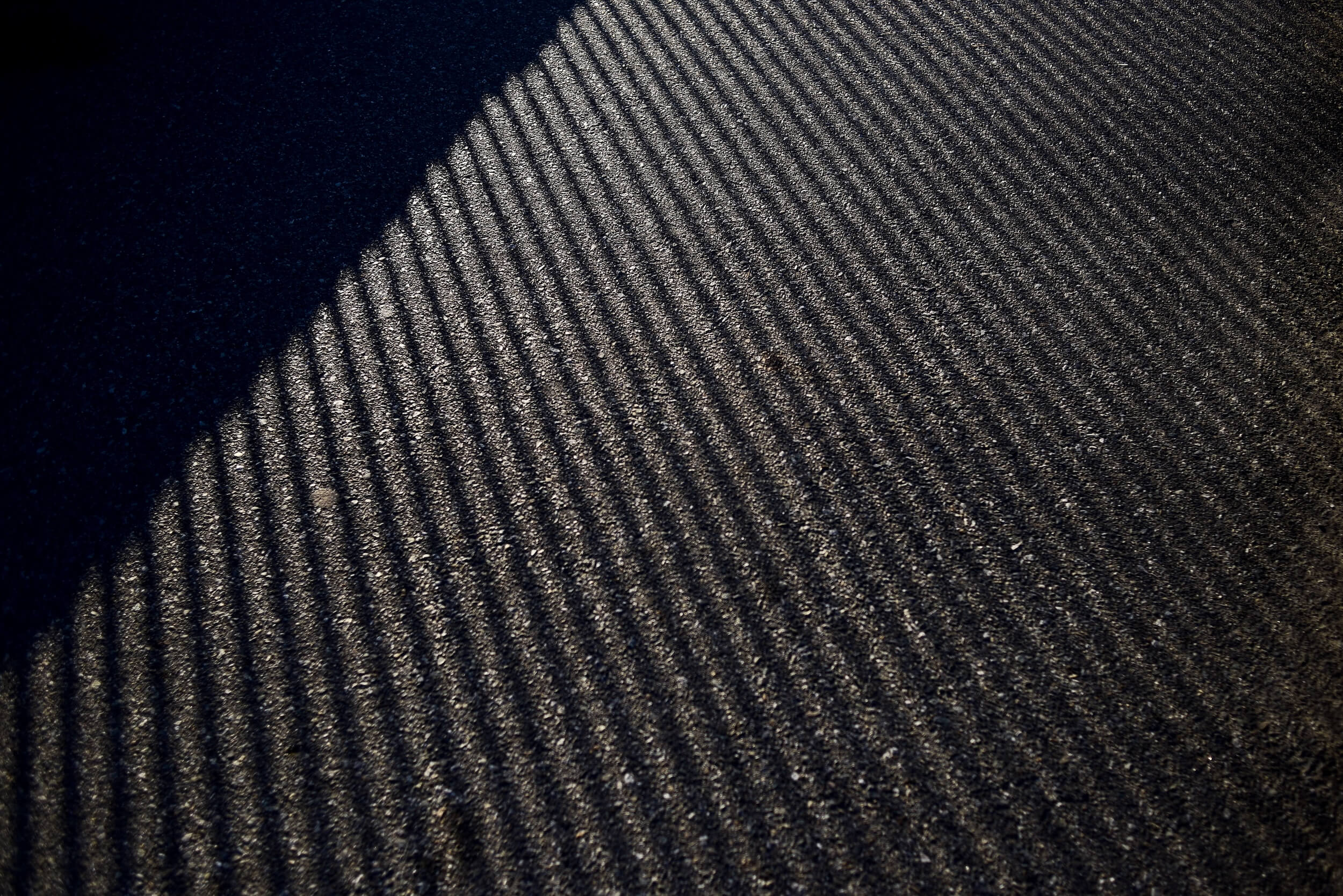 Close-up of a dark grey fire-retardant carpet in the sunlight