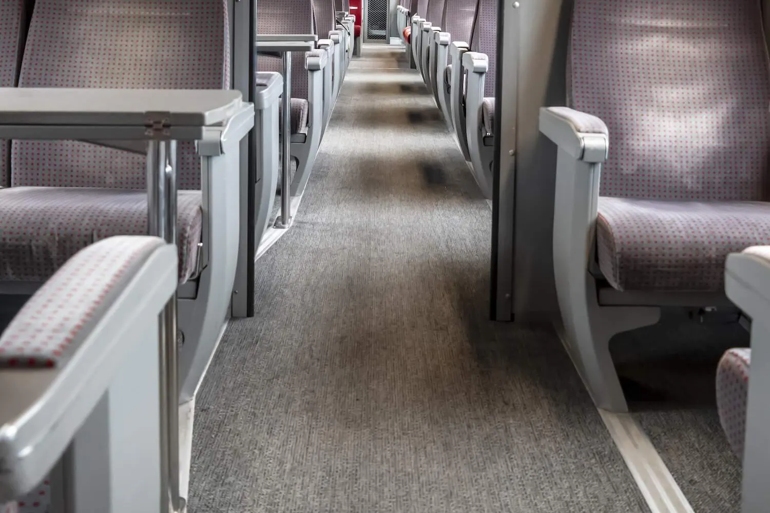 Interior of a train with a carpeted floor using graphite-based backing