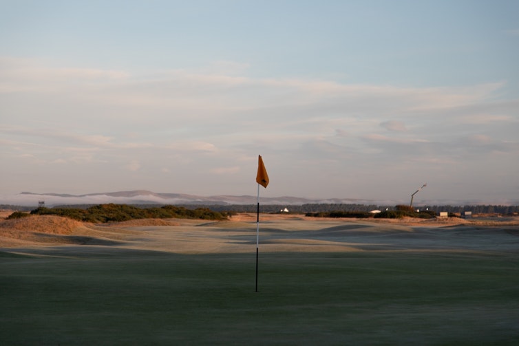 Flag with course and landscape in background sunny morning | Luke Charles Photographer