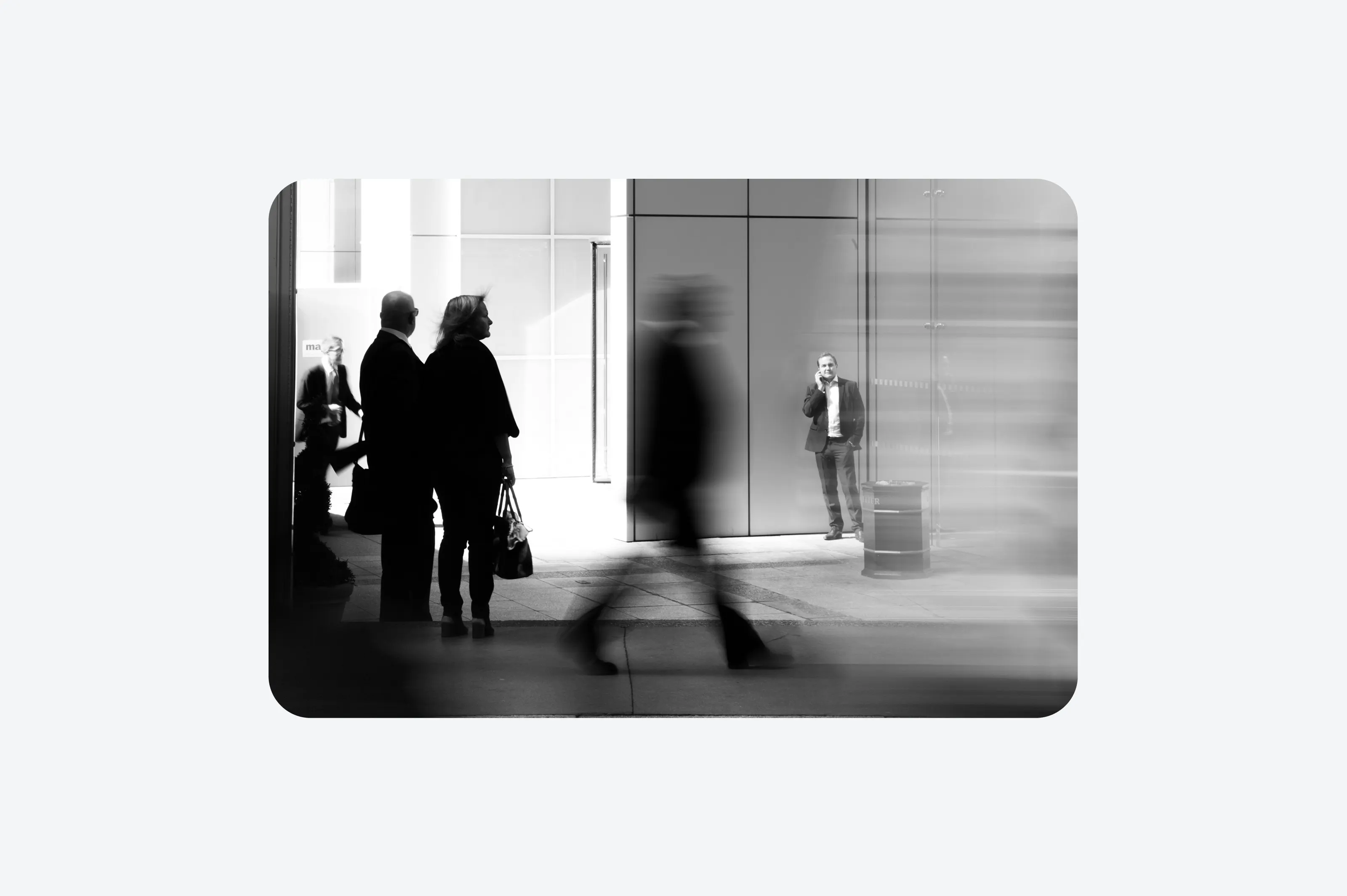 A monochrome image of busy business people.