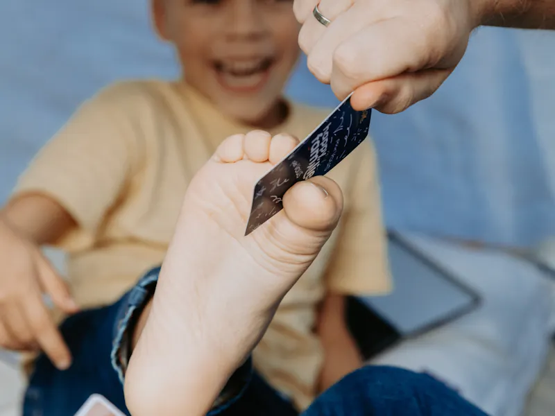 Child playing a personalized game of Happy Families around a table