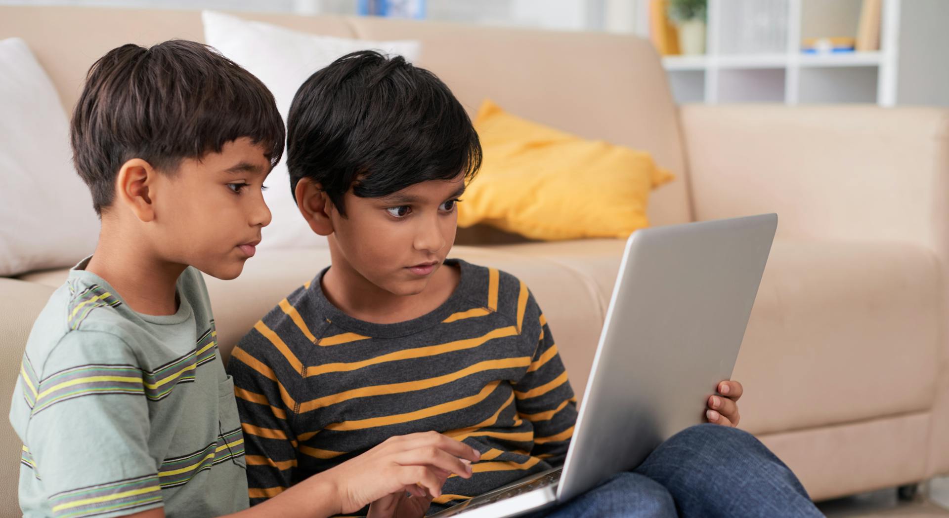 Two children using a laptop