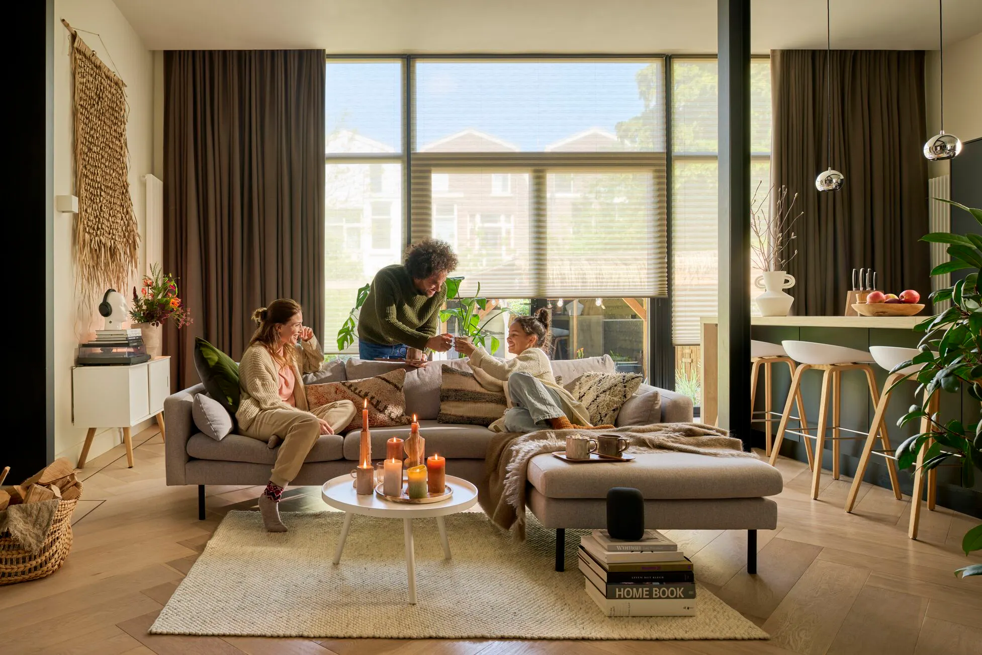 White sheer duette blinds layered with brown curtains in a cozy apartment living room 
