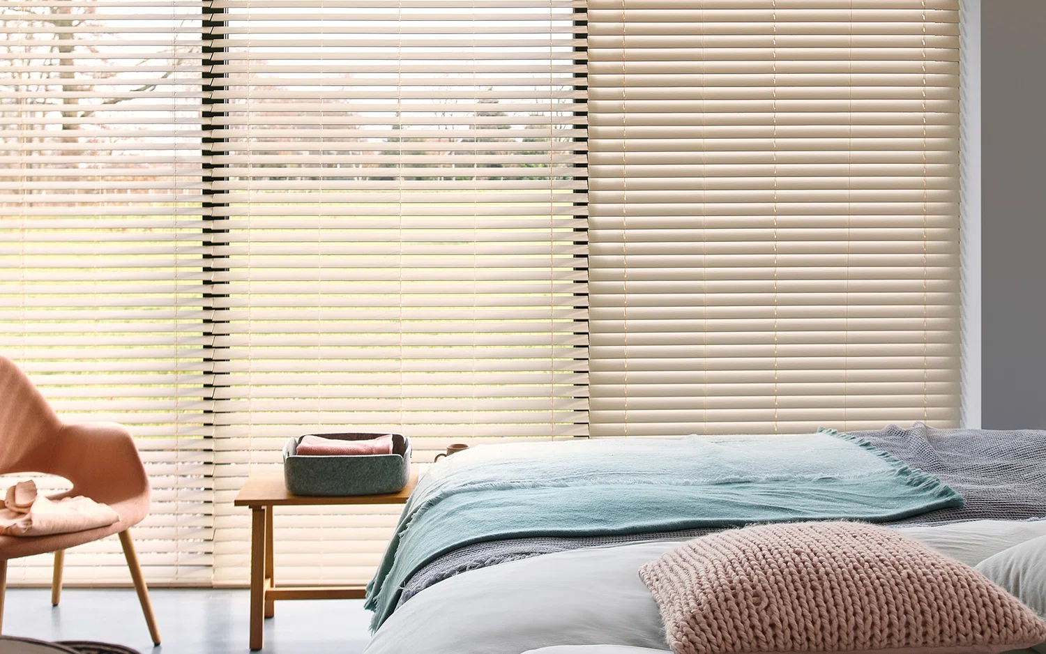 Light bedroom with cream wood Venetian blinds