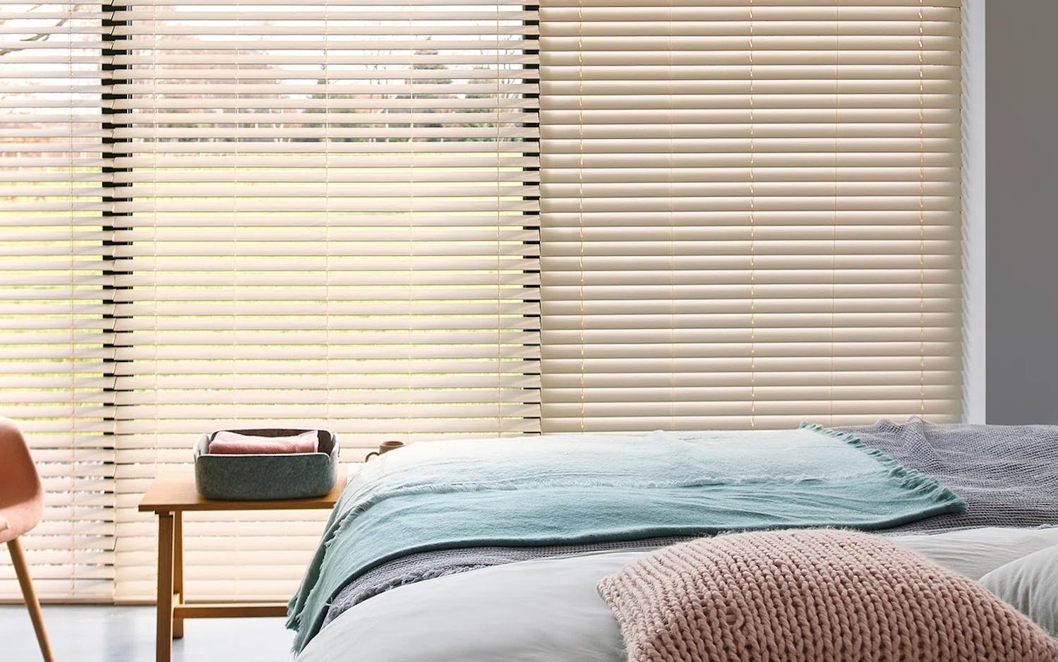Light bedroom with cream wood Venetian blinds