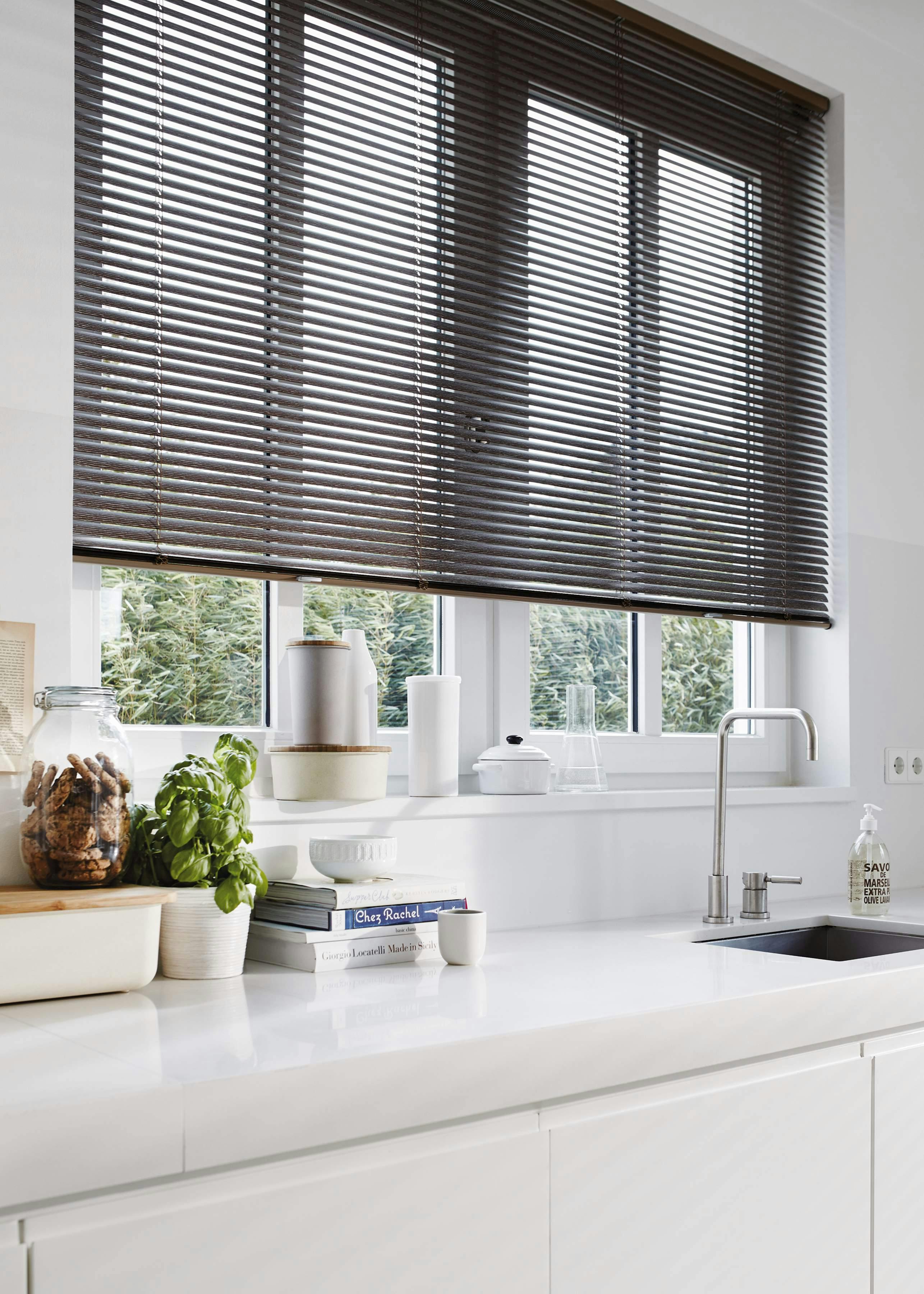 Modern kitchen with grey Venetian blinds on windows